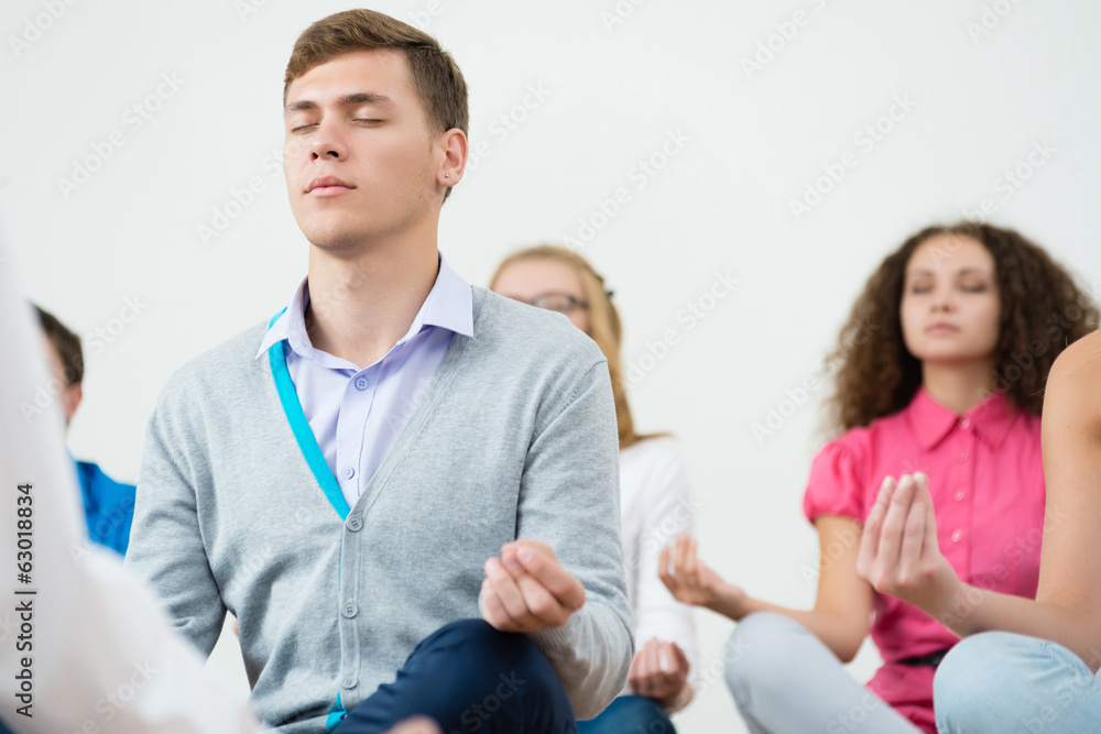 Fototapeta premium group of young people meditating