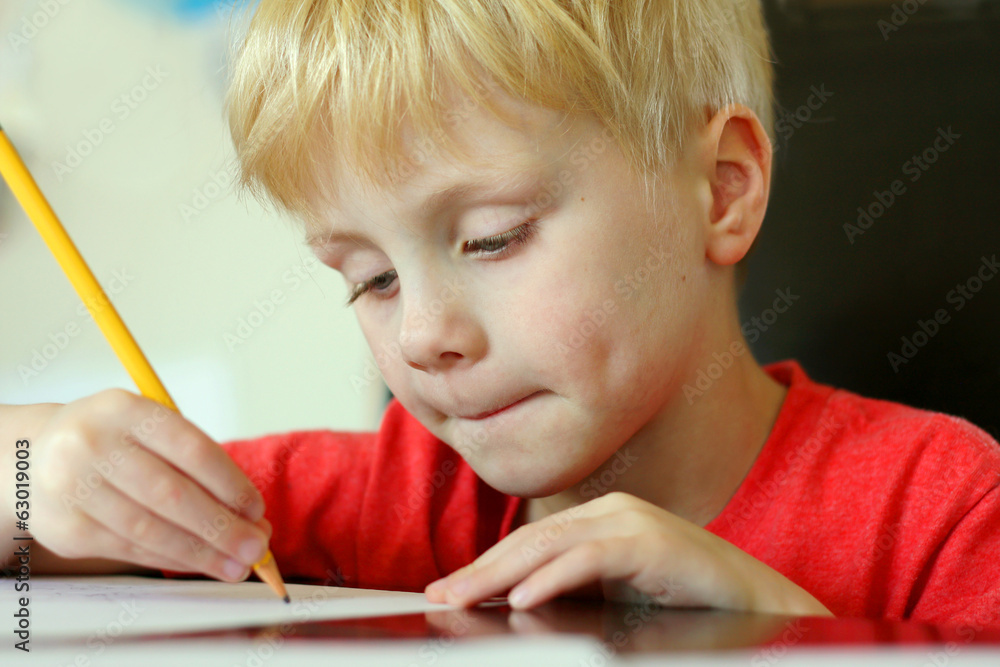 Young Child Drawing on Paper with Pencil Young Child Drawing on Paper with Pencil