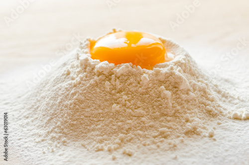 Broken egg in flour