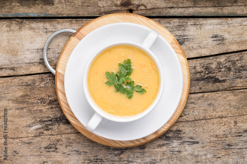 Pea soup in White Bowl on grunge wood background. Top View Pea soup in White Bowl on grunge wood background. Top View