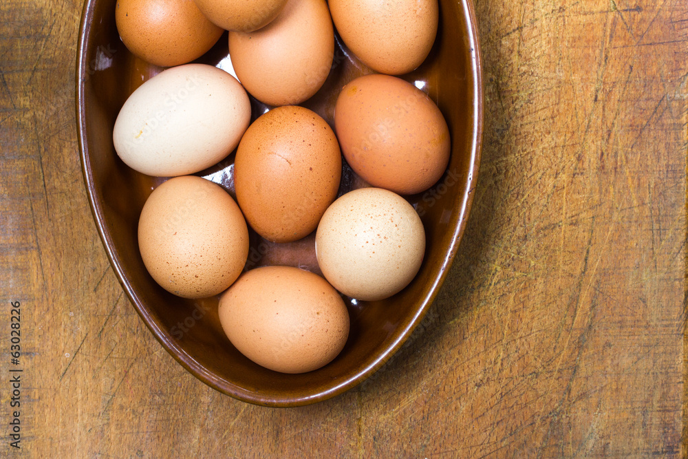 Organic, free-range eggs in terracotta bowl Organic, free-range eggs in terracotta bowl