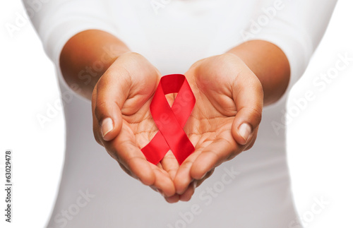 hands holding red AIDS awareness ribbon