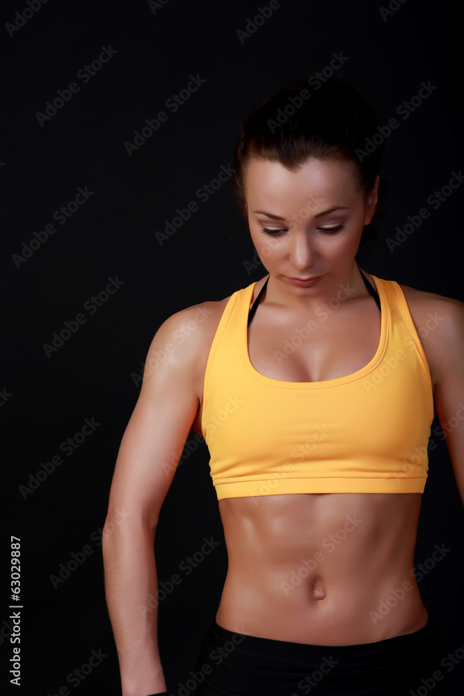 Young attractive female fitness model posing