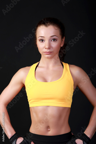 Young attractive female fitness model posing
