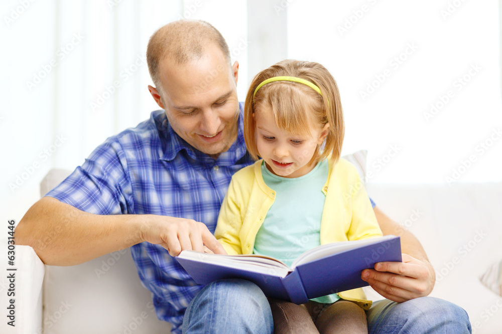 smiling father and daughter with book at home smiling father and daughter with book at home