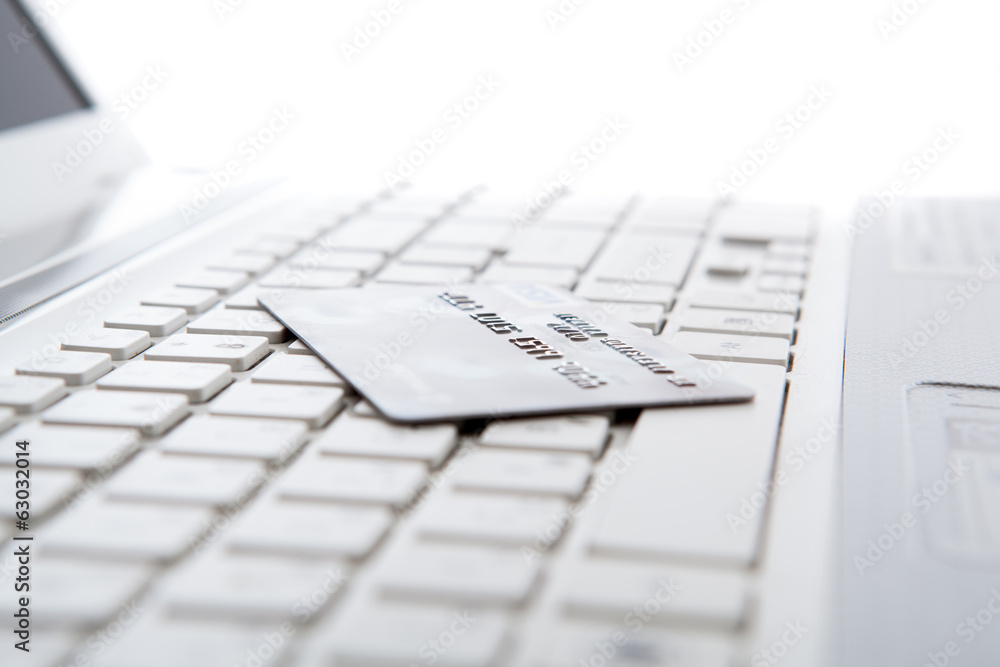 bank card on laptop keyboard bank card on laptop keyboard