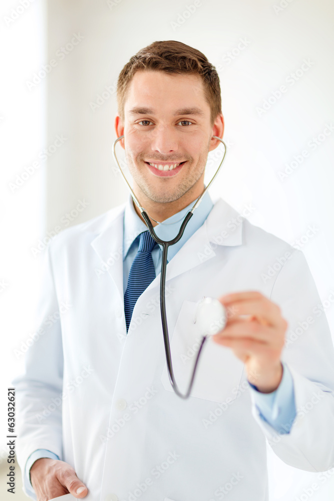 smiling male doctor with stethoscope in hospital smiling male doctor with stethoscope in hospital