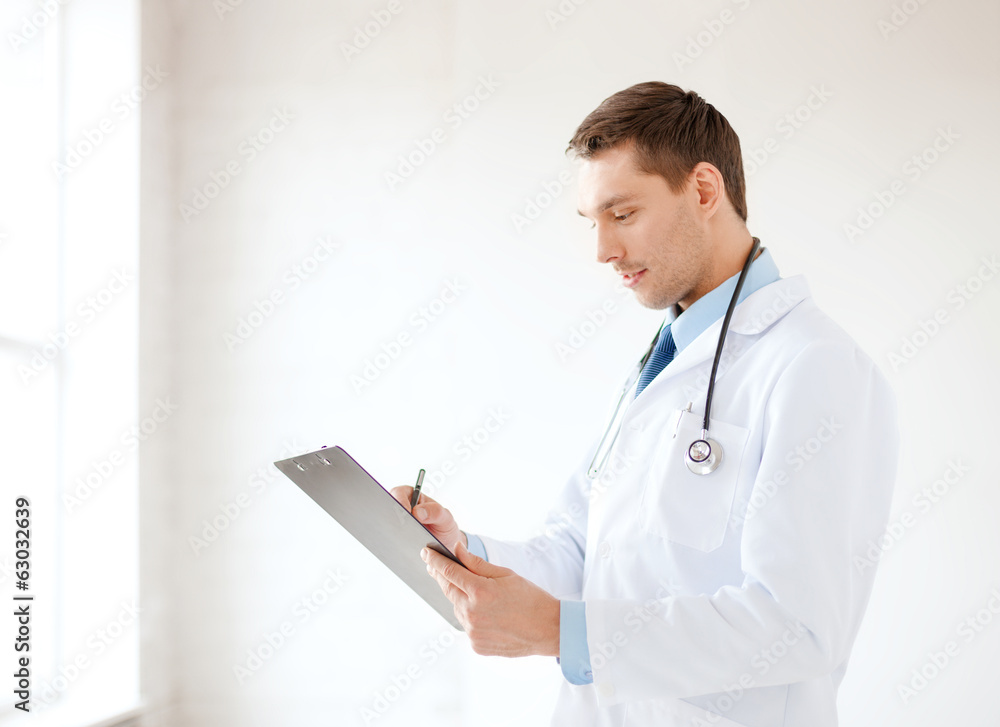 smiling male doctor with stethoscope and clipboard smiling male doctor with stethoscope and clipboard
