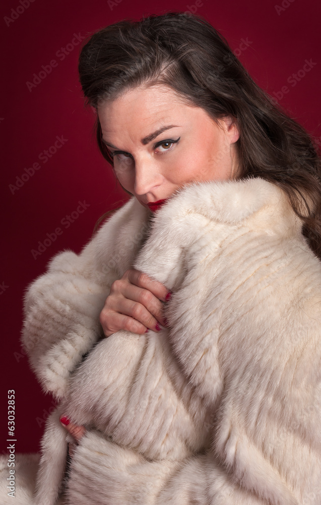Pinup Girl Peers Over Collar of White Fur Coat Pinup Girl Peers Over Collar of White Fur Coat