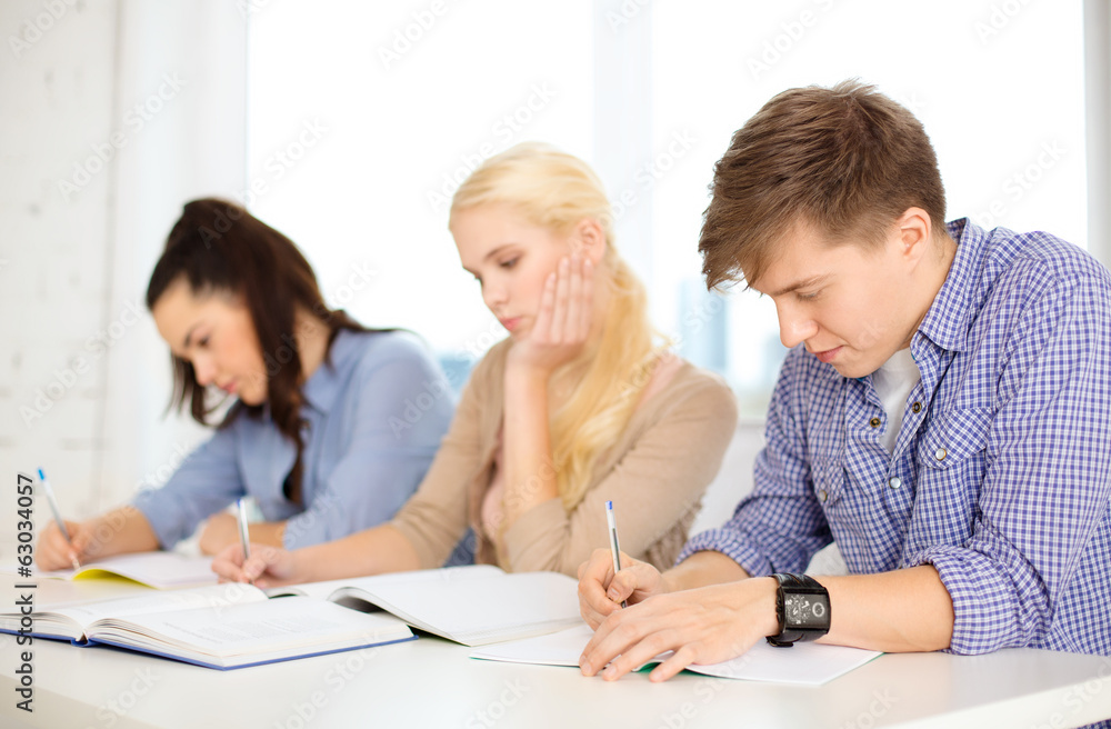 tired students with notebooks at school tired students with notebooks at school