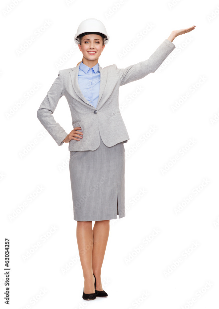smiling businesswoman in helmet holding something smiling businesswoman in helmet holding something