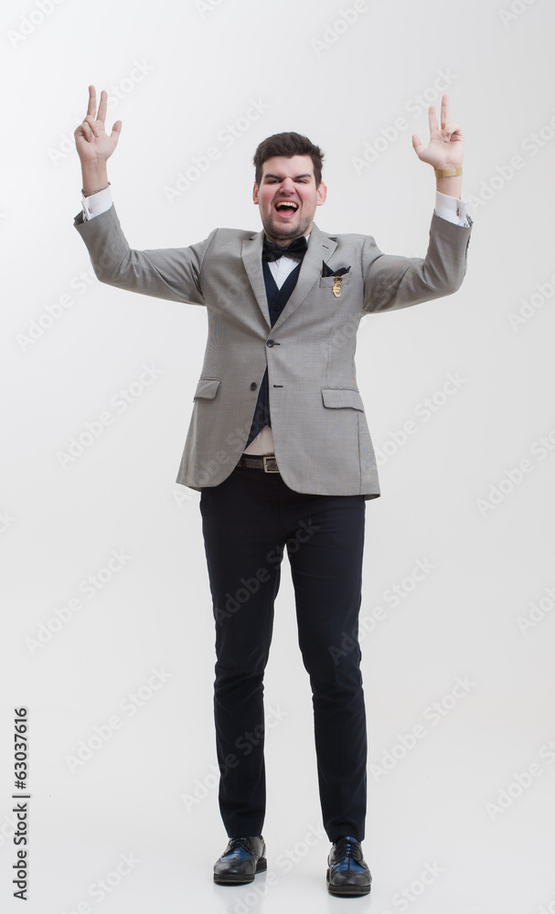 Businessman doing hand gestures. A man raises his hands up. Businessman doing hand gestures. A man raises his hands up.
