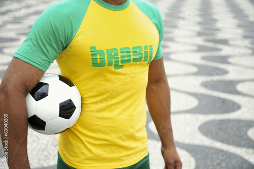 Brazilian Soccer Player in Brasil Shirt Holding Football Rio photo