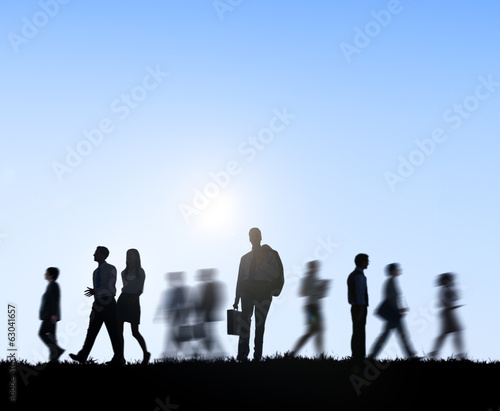 Group of Business People Walking At Sunset