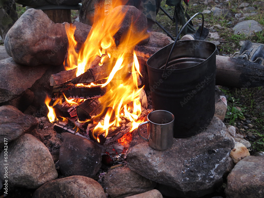 tourist fire with a kettle and a mug tourist fire with a kettle and a mug