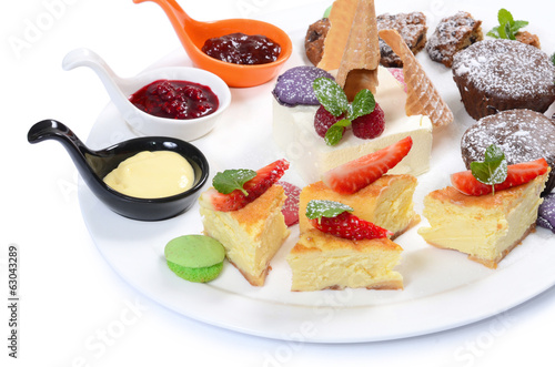 Plate of different desserts isolated