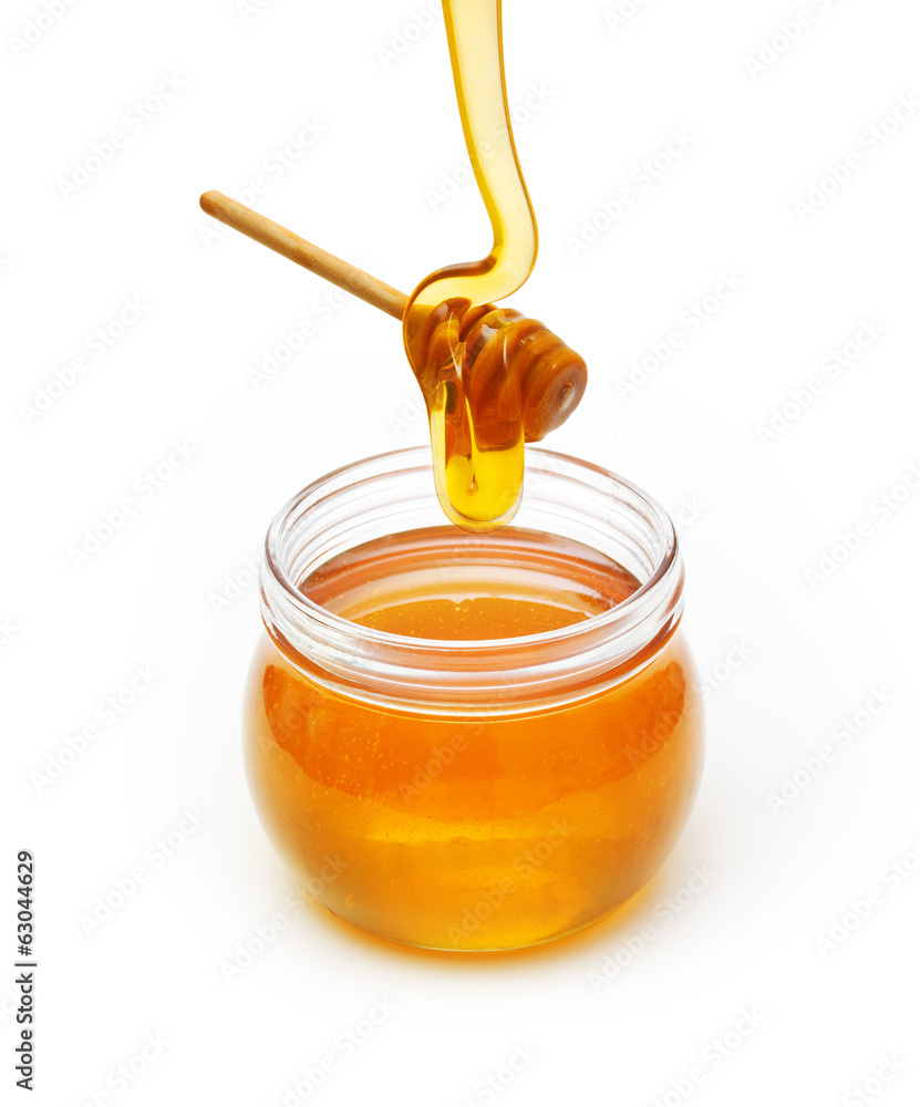 Bowl with honey and wooden dipper on white background Bowl with honey and wooden dipper on white background