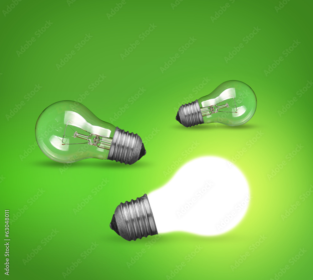 idea concept whit glowing light bulb on green background idea concept whit glowing light bulb on green background