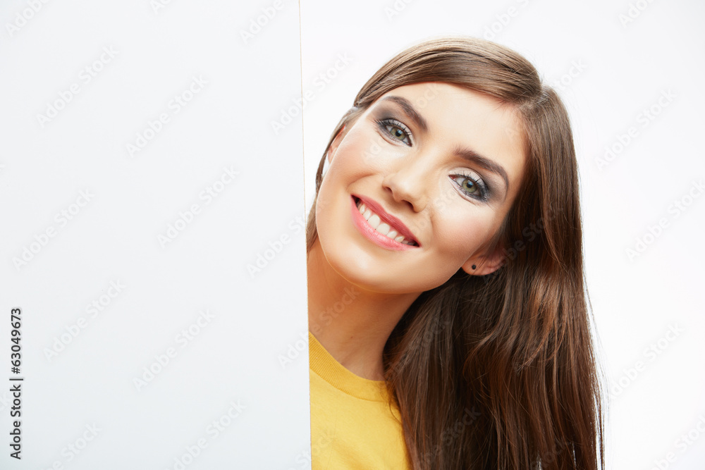 Teenager girl hold white blank paper. Young smiling woman show b Teenager girl hold white blank paper. Young smiling woman show b