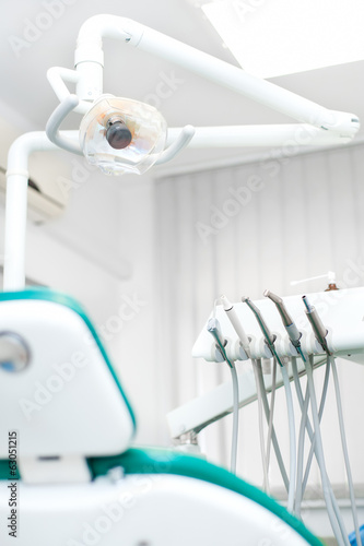 Close-up view of dental tools and professional chair at dentist
