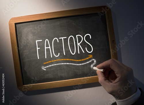 Fotografie Hand writing Factors on chalkboard