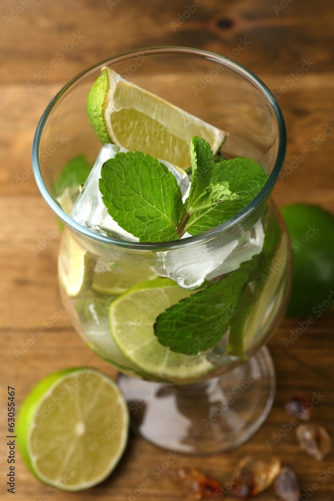 Ingredients for lemonade in glass, on wooden table Ingredients for lemonade in glass, on wooden table