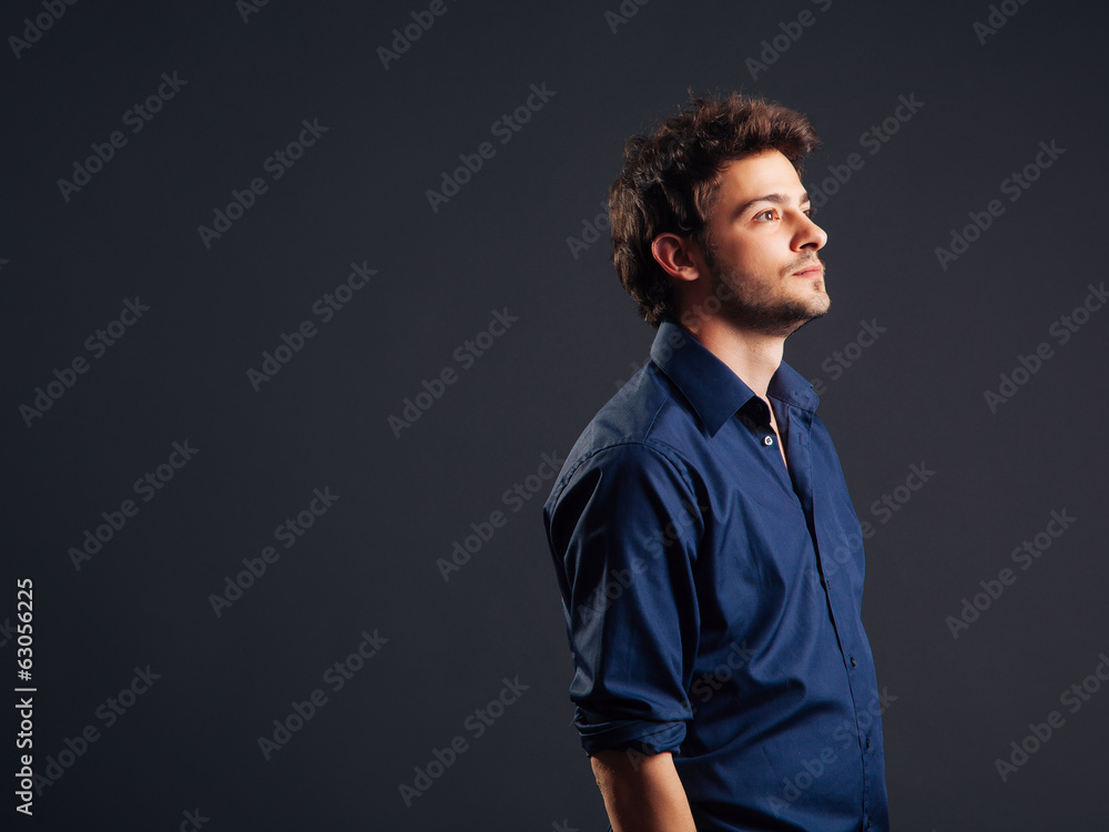 Fototapeta premium A handsome young man looking upwards while in thought