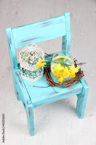 Fototapeta Naklejka Na Ścianę i Meble -  Beautiful spring flowers on blue old wooden chair