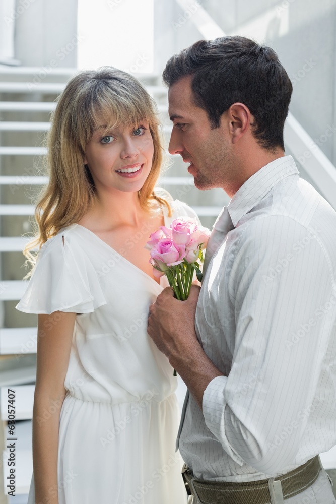 Loving young couple with flowers at home Loving young couple with flowers at home