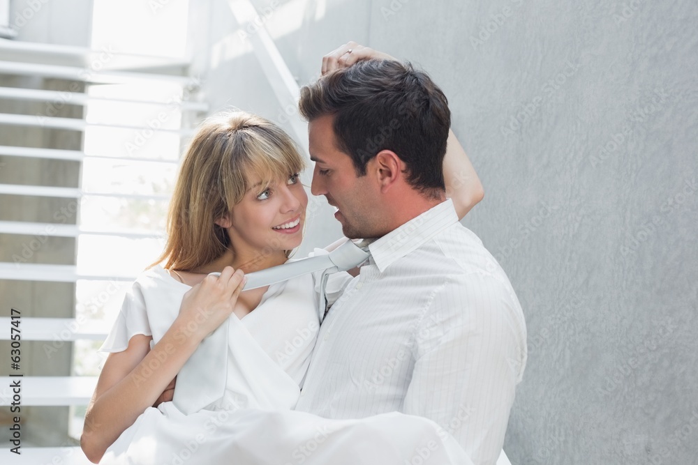 Man carrying woman against stairs Man carrying woman against stairs