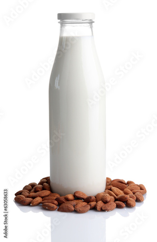 Almond milk in bottle with almonds  isolated on white