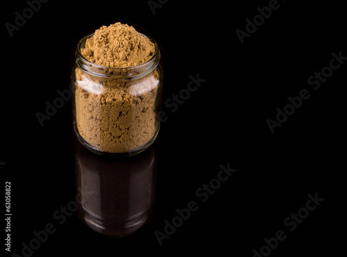 Korma spice powder on black background