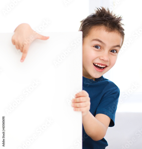 Cute boy is holding blank banner