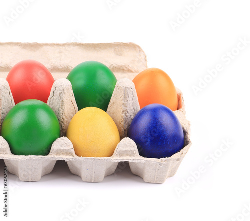Cardboard egg box with Easter colored eggs.