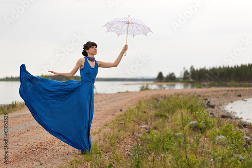 A girl tries to keep a umbrella which pulls out a wind