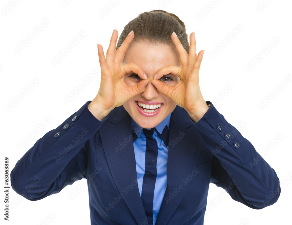 Happy business woman looking through eyeglasses shaped hands Happy business woman looking through eyeglasses shaped hands