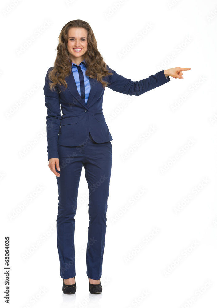 Full length portrait of business woman pointing on copy space Full length portrait of business woman pointing on copy space