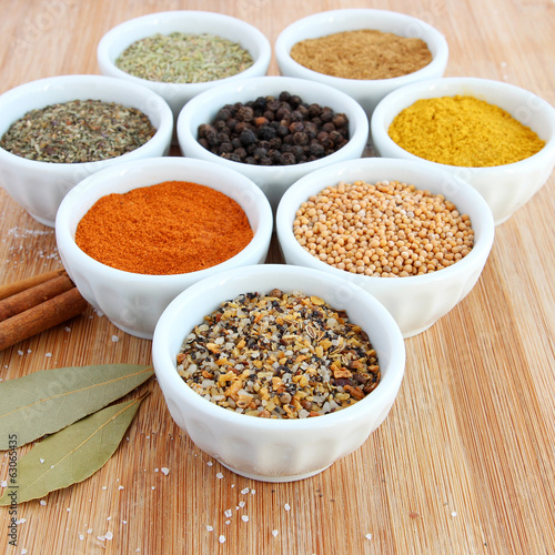 Spices in white bowls – Montreal steak spice in the foreground