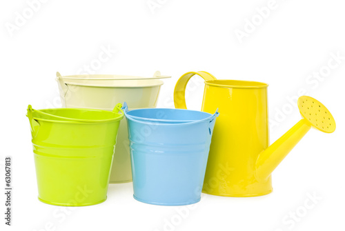 colorful buckets and watering can isolated on white background.