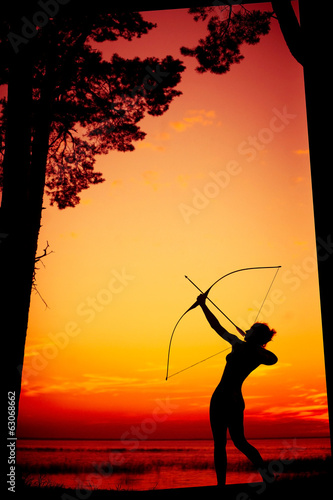 Sexy nude archer at sunset