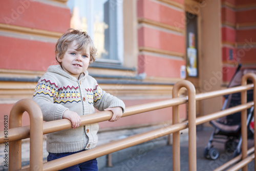 Little caucasian toddler boy having fun, outdoors