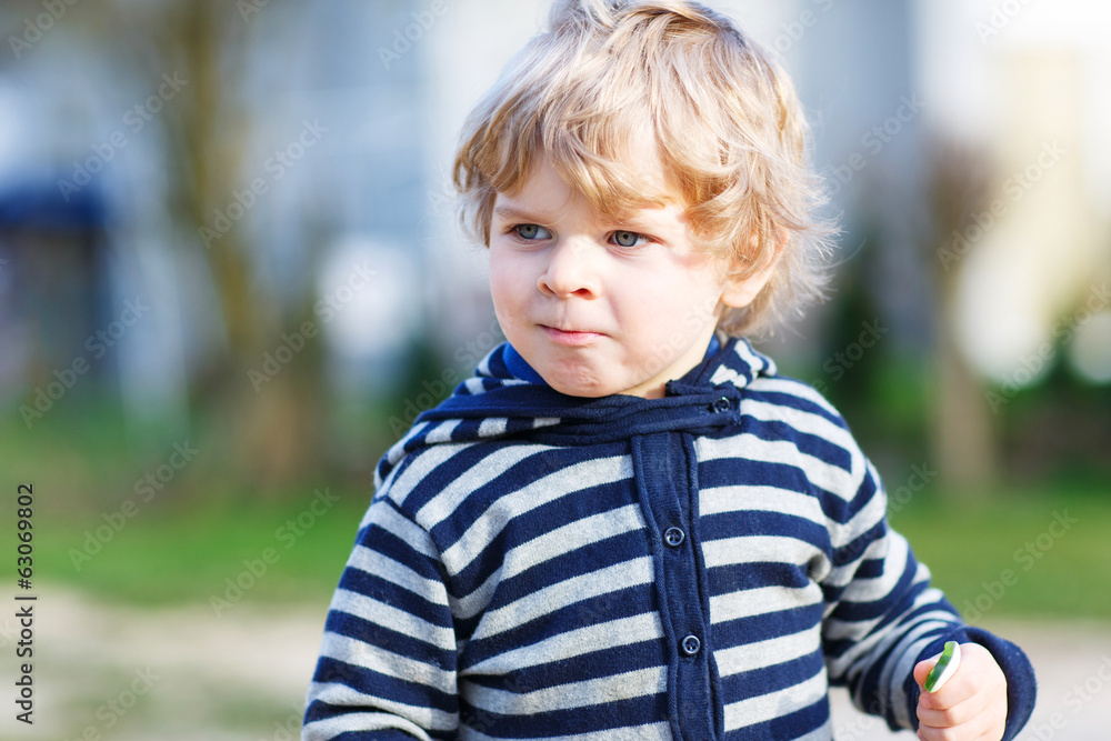 Portrait of toddler boy having fun on outdoor playground Portrait of toddler boy having fun on outdoor playground