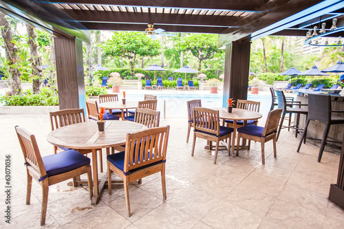 Hotel outdoor cafe with white table and chairs