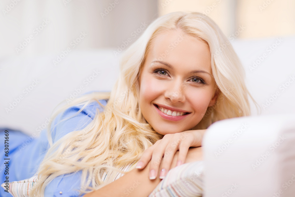smiling young woman lying on sofa at home smiling young woman lying on sofa at home