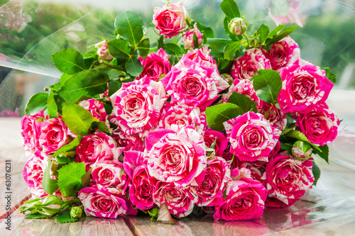 Beautiful purple tiger roses  floribunda  on a wooden background