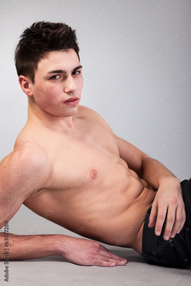 Healthy muscular young man on grey background Healthy muscular young man on grey background