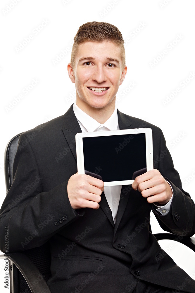 Young businessman at suit sitting and shows tablet pc Young businessman at suit sitting and shows tablet pc