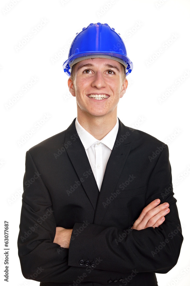 Young businessman in suit with a helmet looks up Young businessman in suit with a helmet looks up