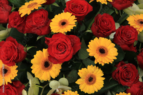 yellow and red flowers in a bridal arrangement