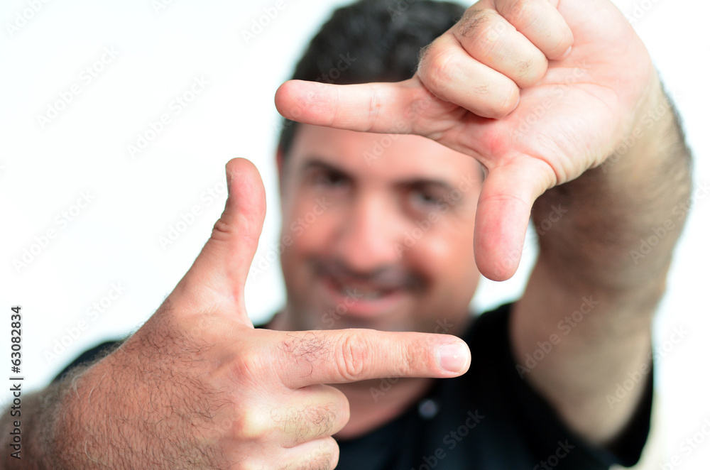 Fototapeta premium Happy mature man creating frame with fingers
